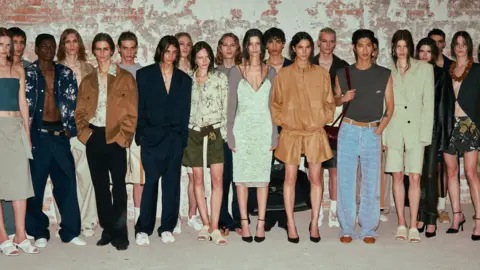 Alexandra Mavros Models pose for the camera backstage at System