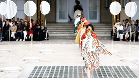 Mohammed Badra, EPA Models walk the runway at Issey Miyake