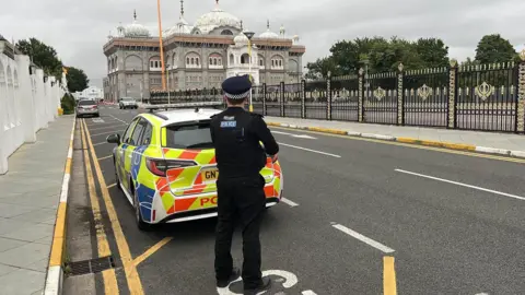 Phil Harrison/BBC A police car outside the gurdwara on Friday morning