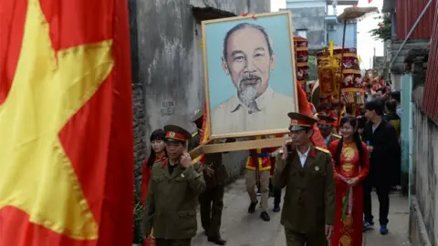AFP Veterans carry a portrait of Ho Chi Minh in a village procession in northern Vietnam (Feb 2015)
