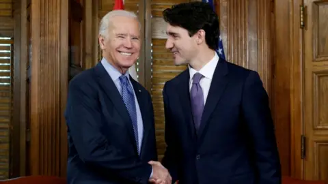 Reuters Canada's Prime Minister Justin Trudeau (R) shakes hands with US Vice President Joe Biden