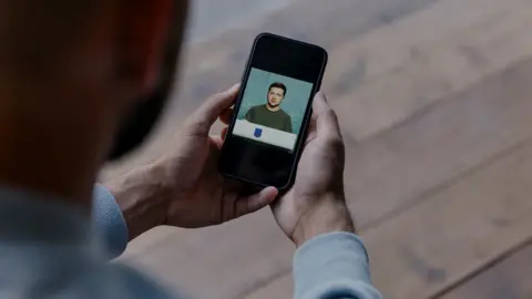 Andriy looking at his phone