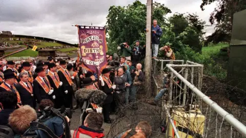 Pacemaker PACEMAKER BELFAST 05/07/98"The Stand-off Begins" Orange men find their part down the Garvaghy Road blocked by steel girders and razor wire errected over the past number of days in the area. The Orangemen say that they will stay as long as it takes to march their traditional route.