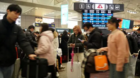 Reuters Travellers wait for their trains at Shanghai Hongqiao railway station, during the Spring Festival travel rush