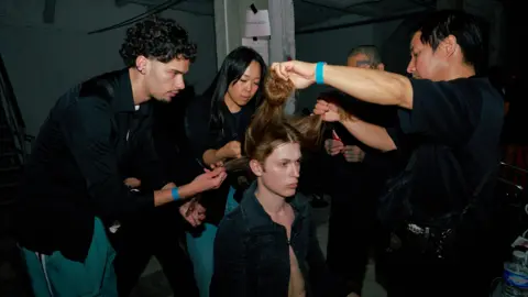 Alexandra Mavros A model's hair is styled backstage at Prototypes