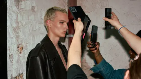 Alexandra Mavros A model poses backstage at the System SS25 show