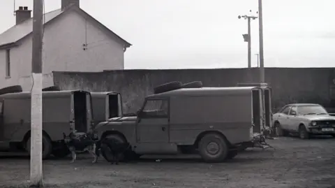 Pacemaker Archive shot of the scene showing police vehicles outside a house