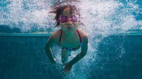 Getty Images A child in goggles under water
