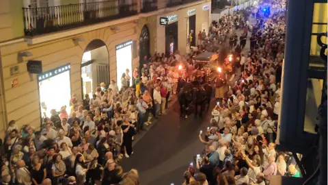 Paco Heras Members of the public stopped to watch the passing cortege