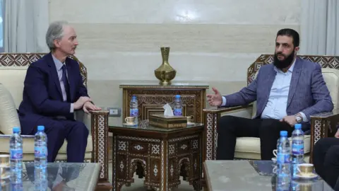 SANA Geir Pedersen (L) holds talks with Hayat Tahrir al-Sham (HTS) leader Ahmed al-Sharaa, also known as Abu Mohammed al-Jolani, in Damascus
