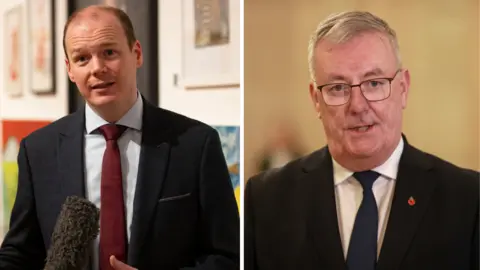 PA Media A composite image of both Communities Minister Gordon Lyons and Health Minister Mike Nesbitt. On the left, Lyons is standing in a blurred gallery talking into a microphone. He is wearing a black suit jacket, a red tie and light coloured shirt. On the right is Nesbitt talking. He is wearing a pair of square framed glasses, a dark suit jacket and tie and a white collared shirt. On his lapel is a poppy pin.