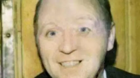 Family handout A family handout of a smiling William McGreanery. He is stood in front of a door