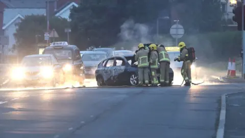 PA Fire fighters tackle a car on fire in Dundonald