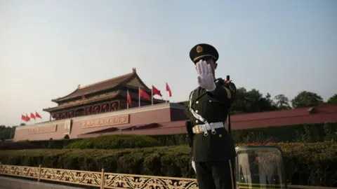 Getty Images A Chinese paramilitary stands near Tiananmen square during the Communist Party's 19th Congress in Beijing