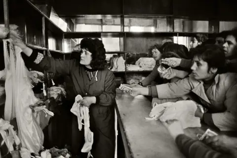 Getty Images Shoppers queue to buy underwear after a rare delivery in 1991