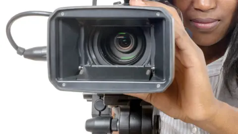 Getty Images A woman with a video camera - generic shot