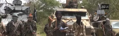 AFP A screengrab taken on 13 July 2014 from a video released by Boko Haram and obtained by AFP shows the leader Abubakar Shekau (C)