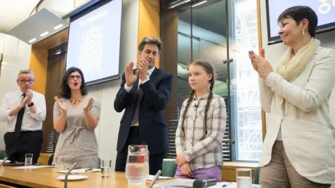 Getty Images Greta Thunberg applauded by politicians Michael Gove, Layla Moran, Ed Miliband and Caroline Lucas