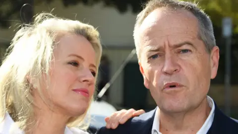 EPA Chloe Shorten (l) looks at Bill Shorten as he speaks to media
