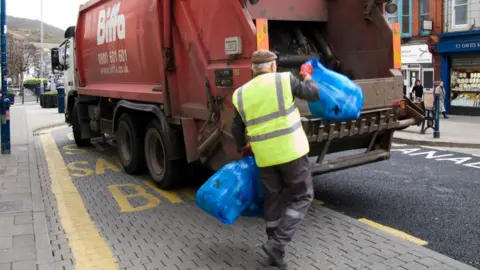 Getty Images Waste being thrown into Biffa truck