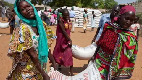 AFP Women in South Sudan receive food aid