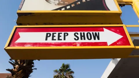 Alamy Showgirl's 'Peep Show' sign with arrow