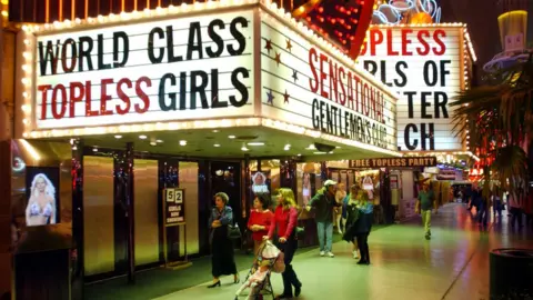 Getty Images Image from 90s of a sign for 'World Class Topless Girls' in Las Vegas' Freemont Street