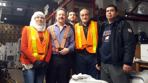 Jim Estill Jim Estill with some Syrian refugees who now work for Danby