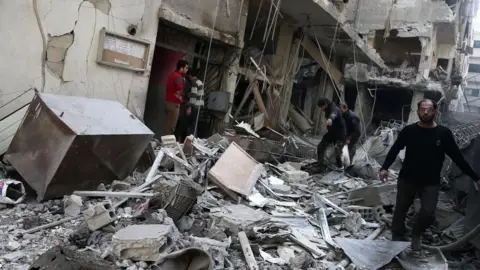 Getty Images A bombed street in Douma, Syria