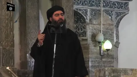 AFP Abu Bakr al-Baghdadi addresses worshippers at the Great Mosque of al-Nuri in Mosul, Iraq, on 5 July 2014