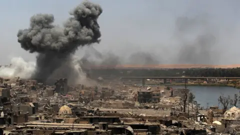 AFP Smoke rises from Mosul following a US-led coalition air strike (9 July 2017)