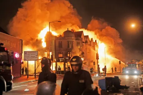 Getty Images Firefighters battle a fire that broke out in Croydon, south London, on 9 August 2011