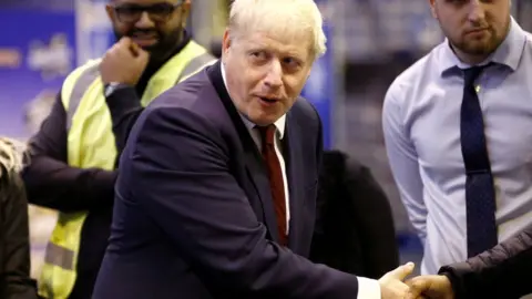 Getty Images Boris Johnson visiting a business in Manchester