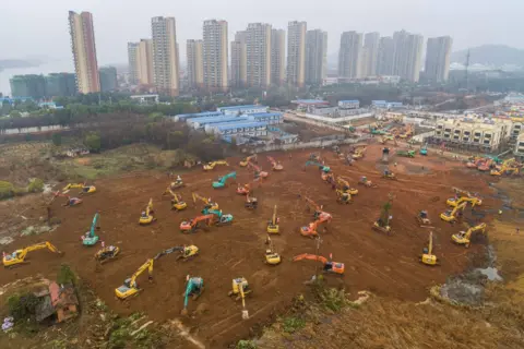 AFP This aerial photo shows excavators at the construction site of a new hospital being built to treat patients from a deadly virus outbreak in Wuhan in China's central Hubei province.