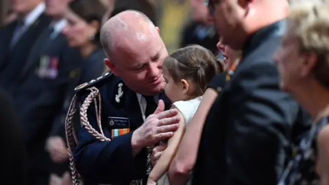 EPA Shane Fitzsimmons talks to Charlotte O'Dwyer, the daughter of NSW RFS volunteer firefighter Andrew O'Dwyer, who was killed in the fires in December