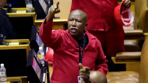 Reuters Opposition Economic Freedom Fighters (EFF) party leader Julius Malema objects as South African President Cyril Ramaphosa attempts to deliver his State of the Nation address at parliament in Cape Town,