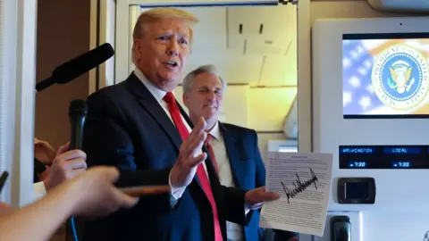 Reuters US President Donald Trump speaks to reporters on board Air Force One