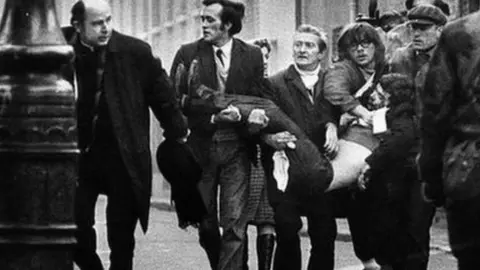 BBC A victim of Bloody Sunday is carried through the streets of Derry