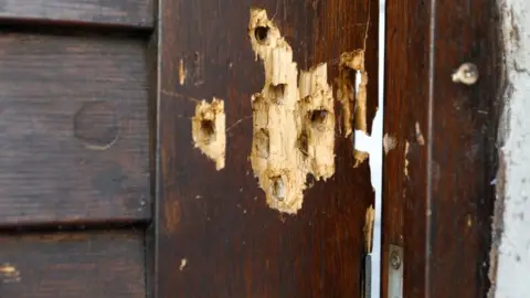 Reuters Bullet holes are seen in the door of a synagogue in Halle, Germany, July 28, 2020