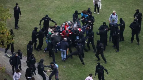 Reuters Belarusian law enforcement officers detain participants of an opposition rally