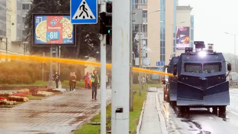 Getty Images Police use a water-cannon truck during a rally to protest against the Belarus presidential election results in Minsk