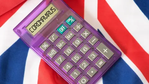Getty Images UK flag with a calculator - the word "coronavirus" is on the screen
