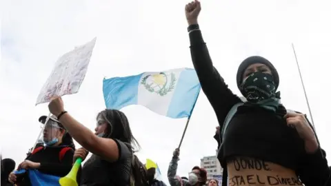 Reuters Demonstrators shout slogans during a protest to demand the resignation of President Alejandro Giammattei in Guatemala City, Guatemala November 22, 2020