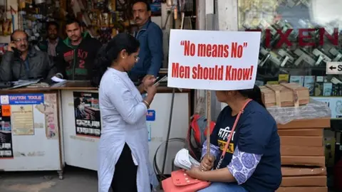 Getty Images A Woman holds a placard during a protest against rape and violence against women in New Delhi on March 6, 2019