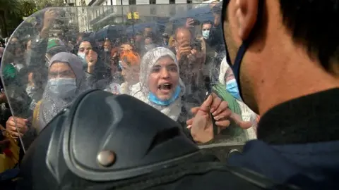 Getty Images Women chant slogans during an anti-government protest in Algiers, Algeria - Monday 8 March 2021