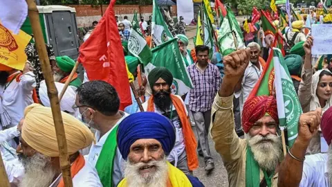 Getty Images Protesting farmers stage a demonstration against the central government's recent agricultural reforms in New Delhi on July 22, 2021.