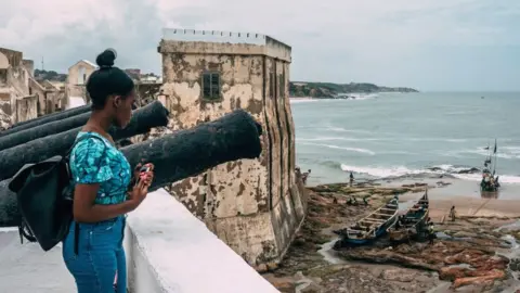 AFP A woman at Ghana's Cape Coast Castle in 2019