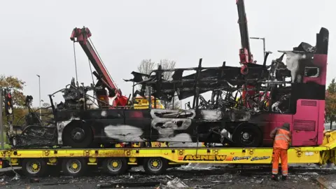 Pacemaker The wreckage of the burnt bus being lifted on to a lorry in Newtownabbey