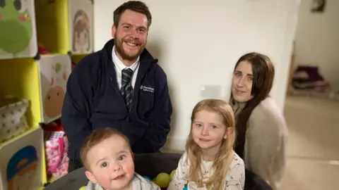 Martin Giles/BBC Louis Brown and his partner Chloe Smith with their children