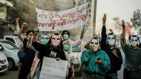YRF Young protesters wearing cat masks in Yangon to disguise themselves